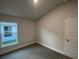 Bright bedroom with gray carpet and window at 13287 Ogden Glade Rd, Dade City, FL 33525