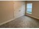 Bedroom with double doors and gray carpet at 13287 Ogden Glade Rd, Dade City, FL 33525