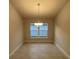 Bright dining room with a chandelier and large window at 13287 Ogden Glade Rd, Dade City, FL 33525