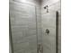 Modern shower with glass enclosure and gray tile at 13287 Ogden Glade Rd, Dade City, FL 33525