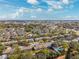 Aerial view of a community with townhouses, pools, and lush landscaping at 13630 Forest Lake Dr, Largo, FL 33771