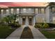 Two-story townhouse at sunset with landscaped front yard at 13630 Forest Lake Dr, Largo, FL 33771