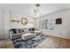 Living room with sectional sofa, decorative rug, and ceiling fan at 13630 Forest Lake Dr, Largo, FL 33771