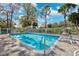 Inviting community pool with lounge chairs at 13630 Forest Lake Dr, Largo, FL 33771