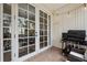 View of the screened patio with grill and seating at 13630 Forest Lake Dr, Largo, FL 33771