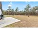 Large backyard with patio, playground, and mature trees at 16125 Magpie Rd, Weeki Wachee, FL 34614