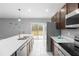 Modern kitchen with stainless steel appliances and white quartz countertops at 16125 Magpie Rd, Weeki Wachee, FL 34614