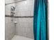 Clean shower with tile surround and glass door at 16125 Magpie Rd, Weeki Wachee, FL 34614