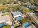 Aerial view showing home with pool, landscaped yard, and surrounding neighborhood at 1695 Honeybear Ln, Dunedin, FL 34698