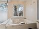 Relax in this updated bathroom, featuring a large jacuzzi tub and shower at 1695 Honeybear Ln, Dunedin, FL 34698