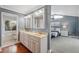 Elegant bathroom with double vanity, large mirrors, and a view of the main bedroom at 1695 Honeybear Ln, Dunedin, FL 34698