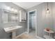 Bathroom with pedestal sink, shower, and built in cabinet at 1695 Honeybear Ln, Dunedin, FL 34698