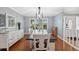 Elegant dining room with a modern chandelier and white table at 1695 Honeybear Ln, Dunedin, FL 34698