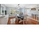 Dining room with hardwood floors, a dark wood table, and white chairs at 1695 Honeybear Ln, Dunedin, FL 34698