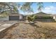 House exterior showcasing a well-maintained lawn and gray garage door at 1695 Honeybear Ln, Dunedin, FL 34698