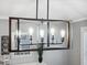 Modern six-light fixture with Edison bulbs above dining table at 1695 Honeybear Ln, Dunedin, FL 34698