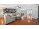 Bright living room featuring hardwood floors and built-in shelving at 1695 Honeybear Ln, Dunedin, FL 34698