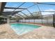 Enjoy the refreshing pool with a screened enclosure at 1695 Honeybear Ln, Dunedin, FL 34698