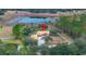 Aerial view of house and property with pond in background at 18010 Okeene Dr, Hudson, FL 34667