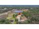 Aerial view of house and surrounding property near pond at 18010 Okeene Dr, Hudson, FL 34667