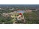 Aerial view showcasing house, expansive lot, and surrounding landscape at 18010 Okeene Dr, Hudson, FL 34667