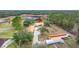 Aerial view showing house and outbuildings on a large lot at 18010 Okeene Dr, Hudson, FL 34667