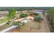 Aerial view of house, detached garage, and fenced area at 18010 Okeene Dr, Hudson, FL 34667