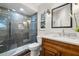 Modern bathroom with glass shower, wood vanity, and stylish tile at 18010 Okeene Dr, Hudson, FL 34667