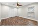 Simple bedroom with wood floors and white closet doors at 18010 Okeene Dr, Hudson, FL 34667