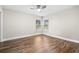 Bright bedroom with hardwood floors and ceiling fan at 18010 Okeene Dr, Hudson, FL 34667