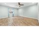 Bedroom with wood-look flooring and window with curtains at 18010 Okeene Dr, Hudson, FL 34667