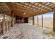 Open-air carport with gravel flooring and wooden beams at 18010 Okeene Dr, Hudson, FL 34667