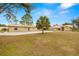 Single-Gathering home with metal roof, palm tree, and large yard at 18010 Okeene Dr, Hudson, FL 34667