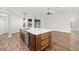 Kitchen island with seating, quartz countertops, and stainless steel sink at 18010 Okeene Dr, Hudson, FL 34667