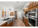 Modern kitchen with stainless steel appliances and a farmhouse sink at 18010 Okeene Dr, Hudson, FL 34667