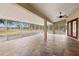 Large screened porch with tile floor and ceiling fan at 18010 Okeene Dr, Hudson, FL 34667