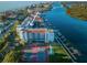 Aerial view of condo building near waterway, tennis courts at 19111 Vista Bay Dr # 304, Indian Shores, FL 33785