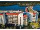 Aerial view of waterfront condo building with parking and water access at 19111 Vista Bay Dr # 304, Indian Shores, FL 33785