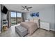 Bright bedroom with water view, ceiling fan, and ample closet space at 19111 Vista Bay Dr # 304, Indian Shores, FL 33785