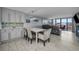 Modern dining area with white table at 19111 Vista Bay Dr # 304, Indian Shores, FL 33785