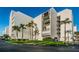 White building exterior with lush landscaping at 19111 Vista Bay Dr # 304, Indian Shores, FL 33785