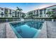 Inviting community pool with surrounding patio at 19111 Vista Bay Dr # 304, Indian Shores, FL 33785