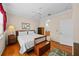 Main bedroom with wood floors and ceiling fan. Access to bathroom and walk-in closet at 1933 Sterling Glen Ct, Sun City Center, FL 33573