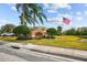 Azalea Trace community entrance with flag and landscaping at 1933 Sterling Glen Ct, Sun City Center, FL 33573