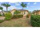 House exterior showcasing a well-maintained lawn and tropical landscaping at 1933 Sterling Glen Ct, Sun City Center, FL 33573