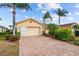 House exterior with a two car garage and landscaping at 1933 Sterling Glen Ct, Sun City Center, FL 33573