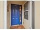 Inviting blue front door with glass panels and tiled entryway at 1933 Sterling Glen Ct, Sun City Center, FL 33573