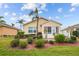 Tan house exterior with landscaping and white deck at 1933 Sterling Glen Ct, Sun City Center, FL 33573