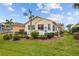 Tan house exterior with landscaping and white deck at 1933 Sterling Glen Ct, Sun City Center, FL 33573