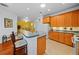 Bright kitchen with wood cabinets, breakfast bar, and tile floors at 1933 Sterling Glen Ct, Sun City Center, FL 33573